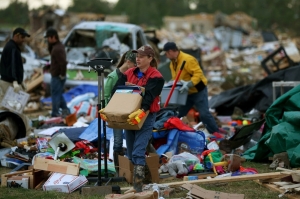 Volunteer Gina Lowe helps a family move belongings from a home that was destroyed by a tornado two days before in Vilonia. Mark Wilson/Getty Images.